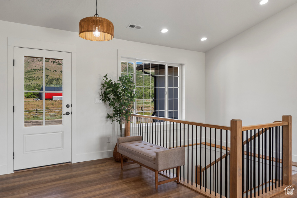 Entryway with wood finished floors, baseboards, and recessed lighting