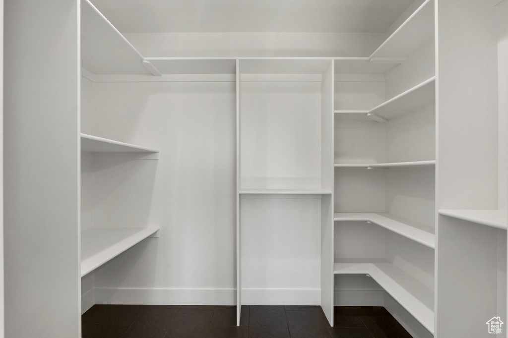 Spacious closet featuring dark tile patterned floors