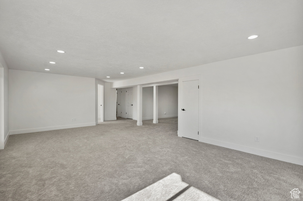 Unfurnished room with recessed lighting, light colored carpet, and baseboards