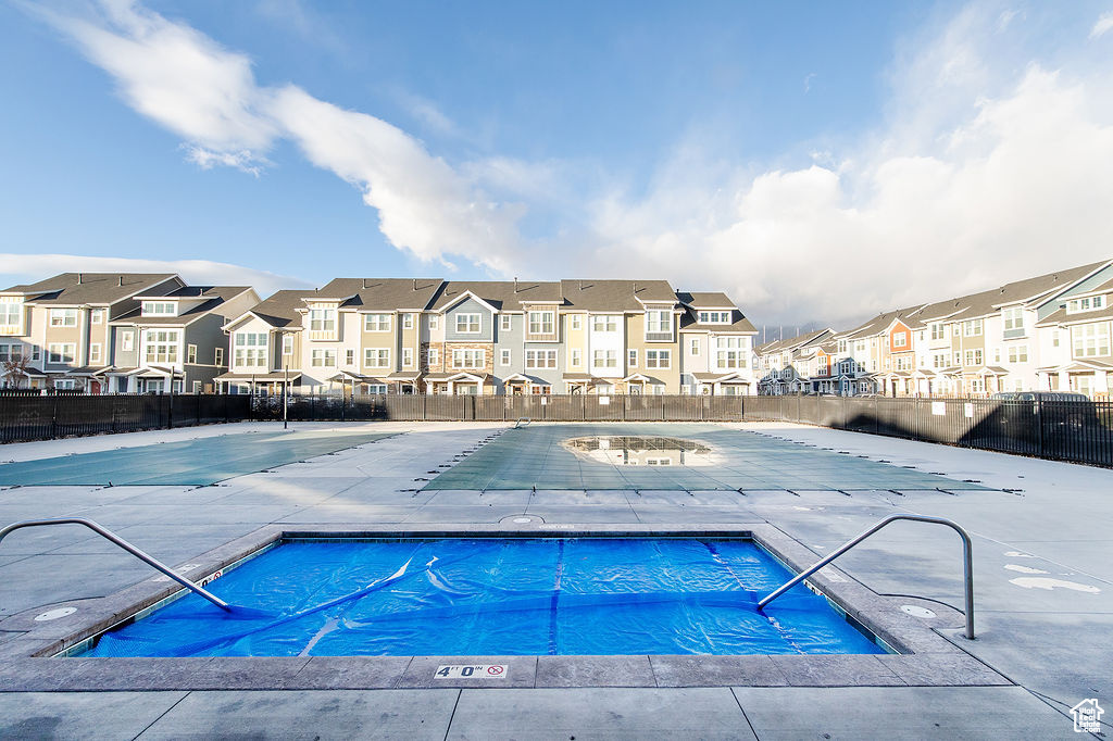 Community pool with a residential view and a patio