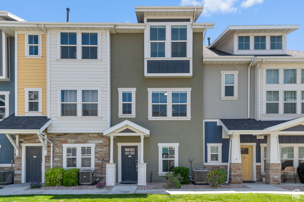 Multi unit property featuring stone siding, central air condition unit, and stucco siding