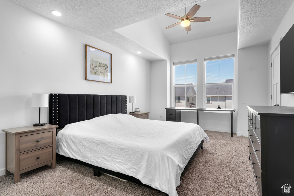 Bedroom featuring light carpet, recessed lighting, baseboards, a textured ceiling, and ceiling fan