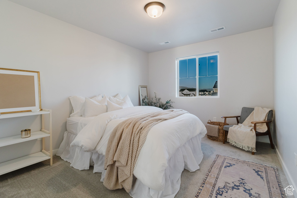 Bedroom featuring carpet floors and baseboards