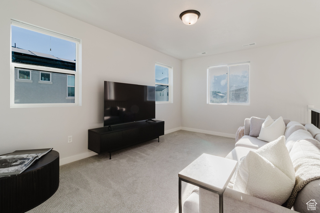 Living area with light carpet and baseboards