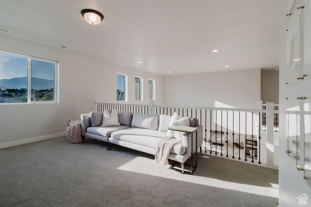 Carpeted living area featuring plenty of natural light, recessed lighting, and baseboards