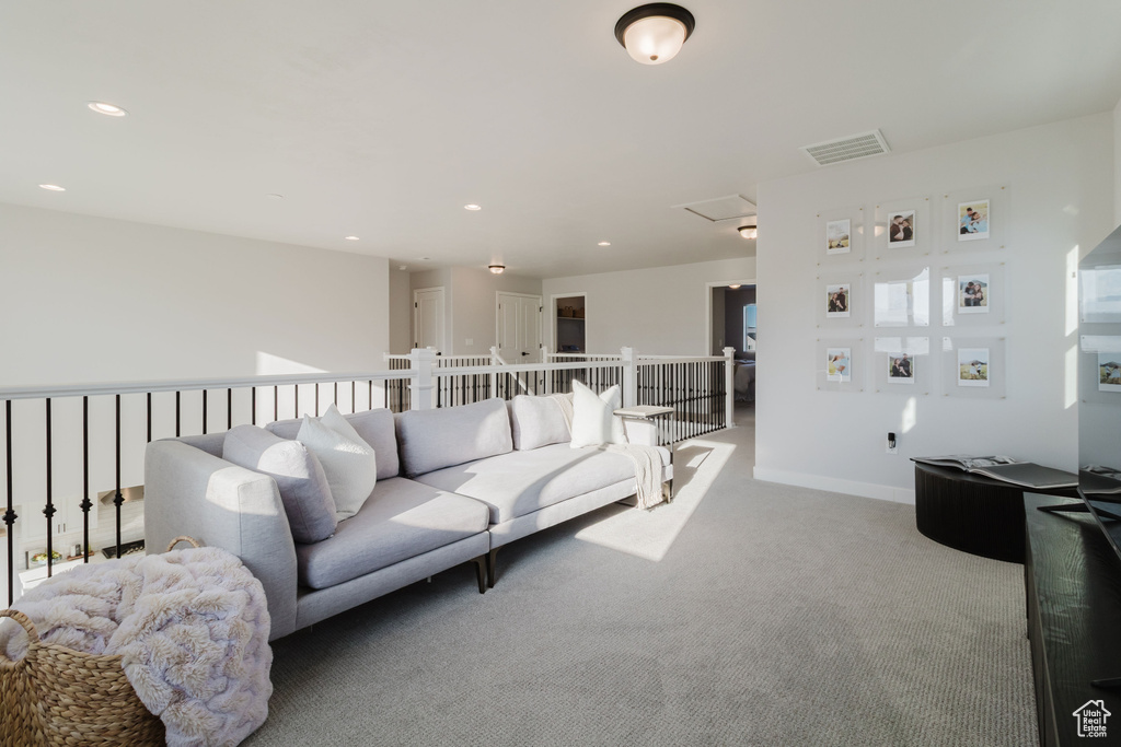 Carpeted living room featuring recessed lighting