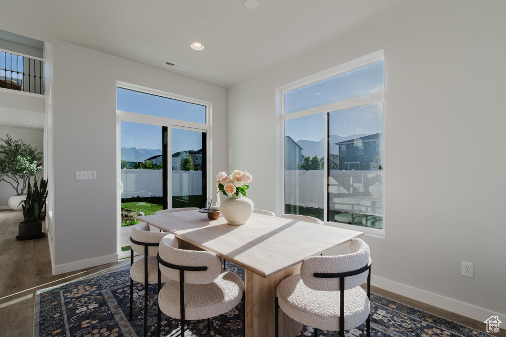 Dining room featuring wood finished floors, baseboards, and recessed lighting