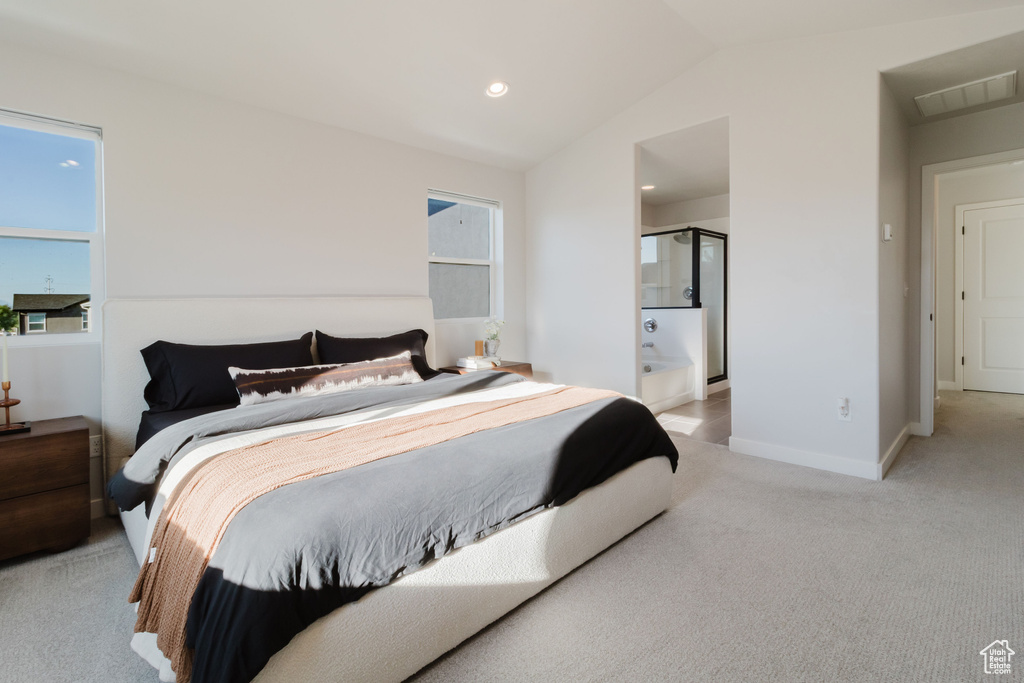 Bedroom featuring light colored carpet, vaulted ceiling, baseboards, ensuite bathroom, and recessed lighting
