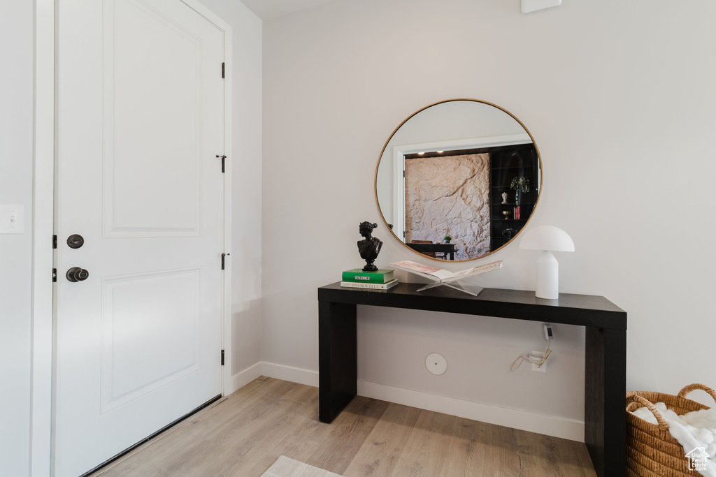 Entrance foyer with light wood-type flooring and baseboards