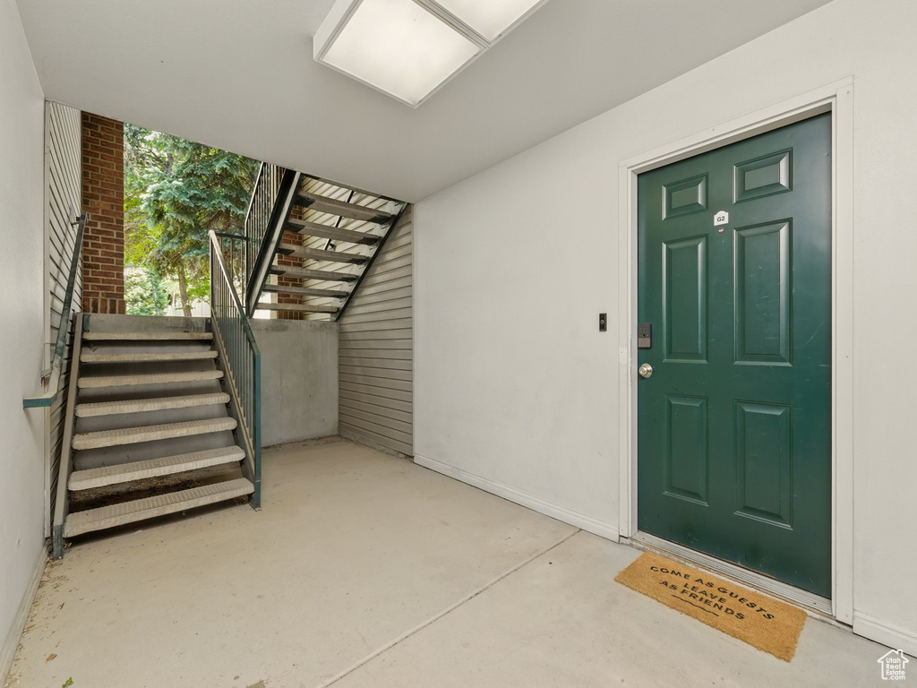 Doorway to property featuring stucco siding