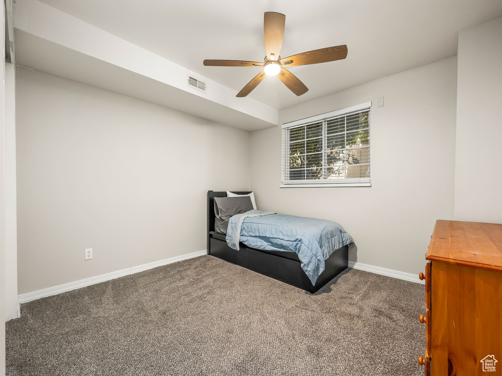 Bedroom with carpet floors, baseboards, and ceiling fan