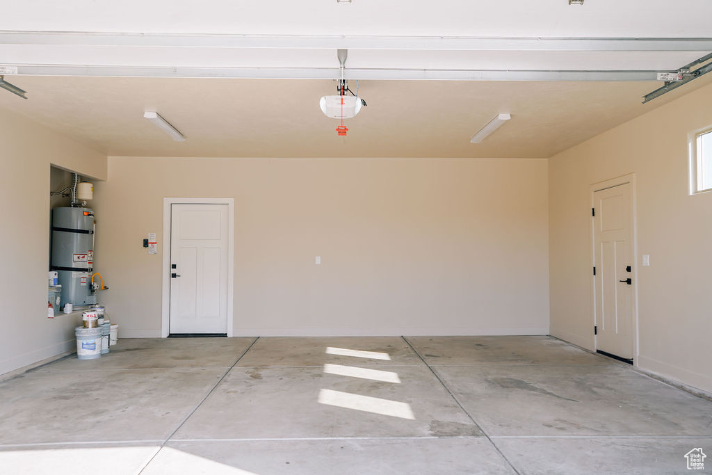 Garage with water heater and baseboards