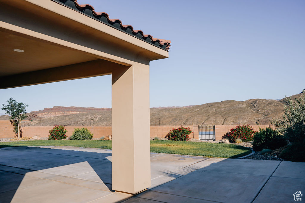 Fenced backyard with a mountain view and a patio area