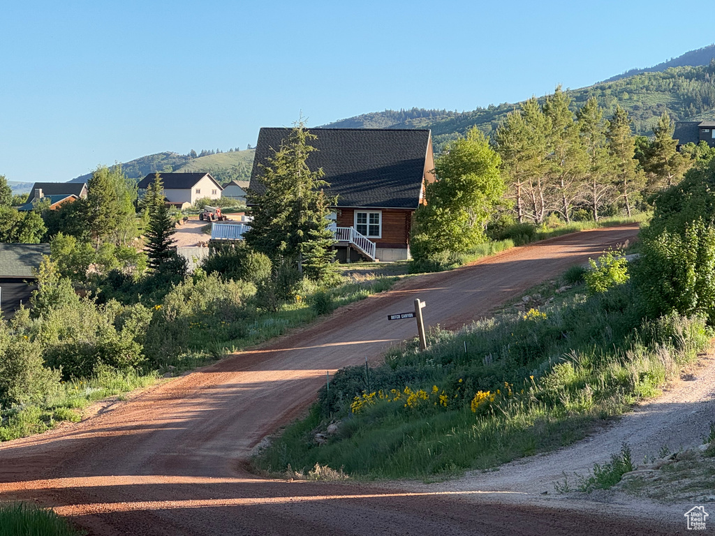 View of dirt / gravel road featuring a mountain view
