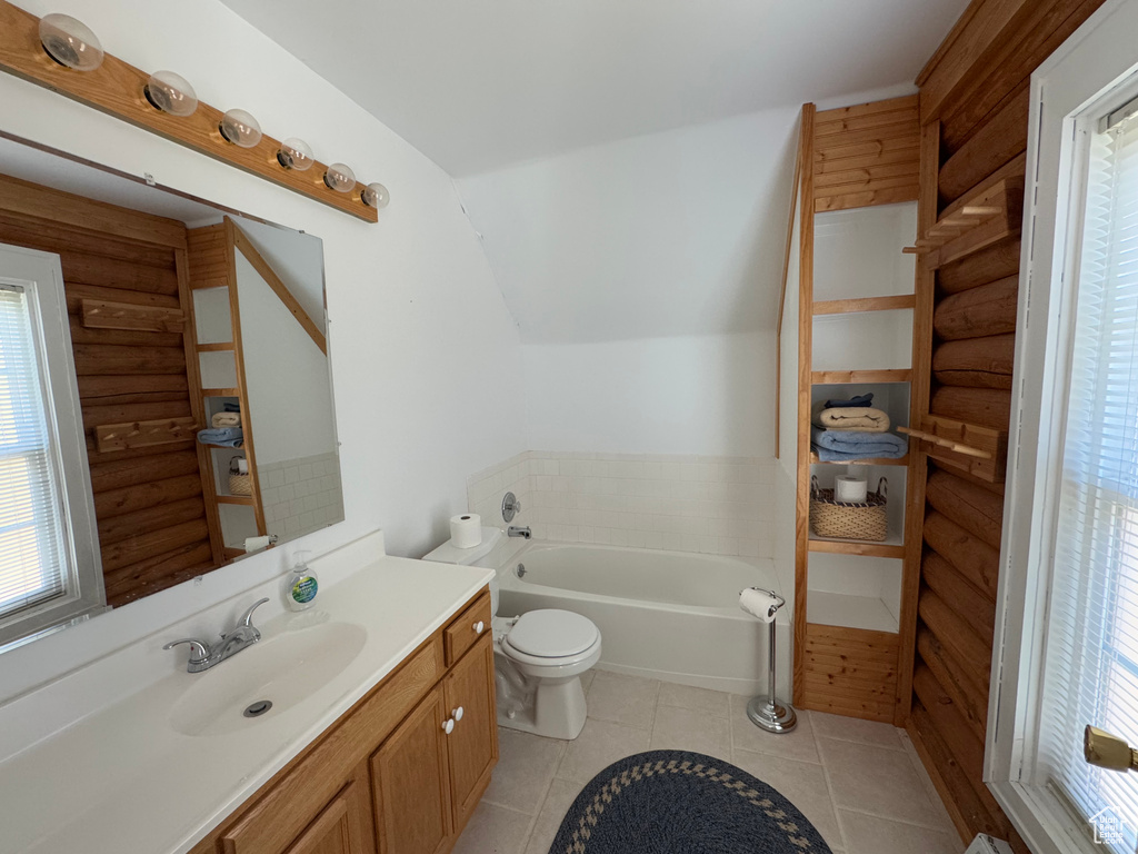 Full bath featuring healthy amount of natural light, log walls, vanity, a bath, and tile patterned floors