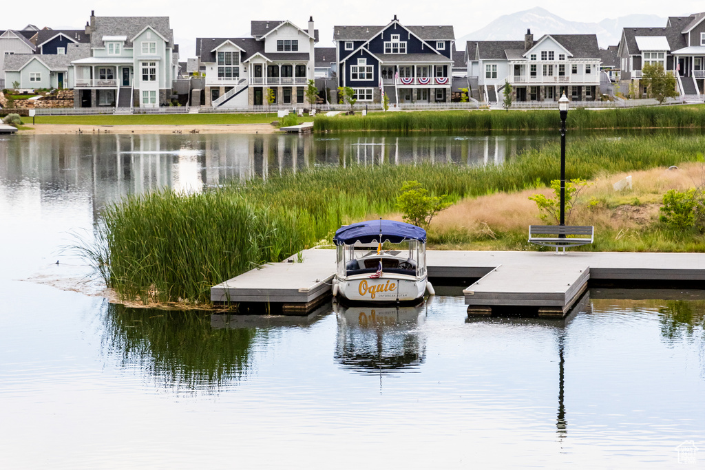 Dock featuring a residential view and a water view