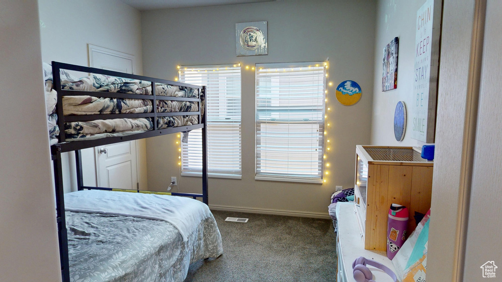 Bedroom featuring carpet and baseboards