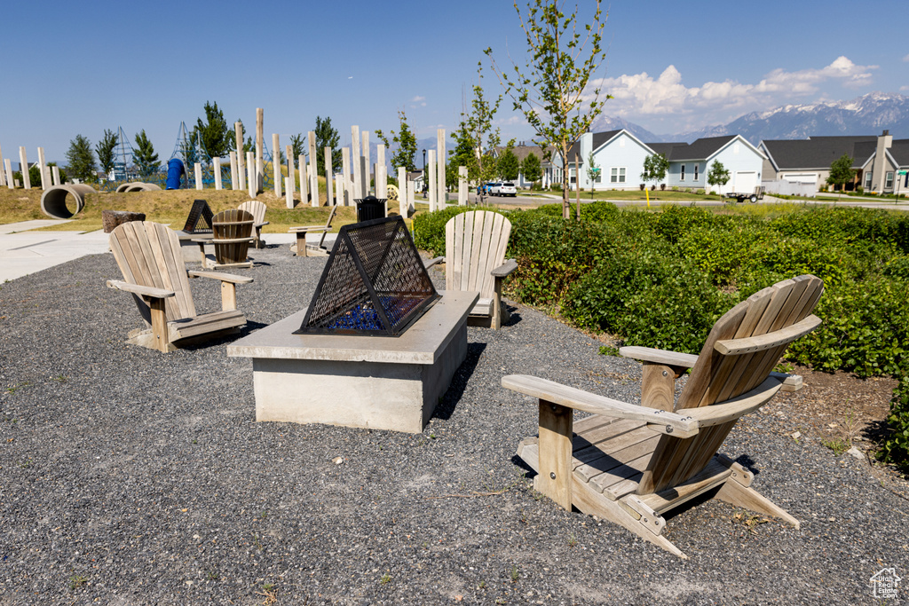 View of patio with an outdoor fire pit and a residential view