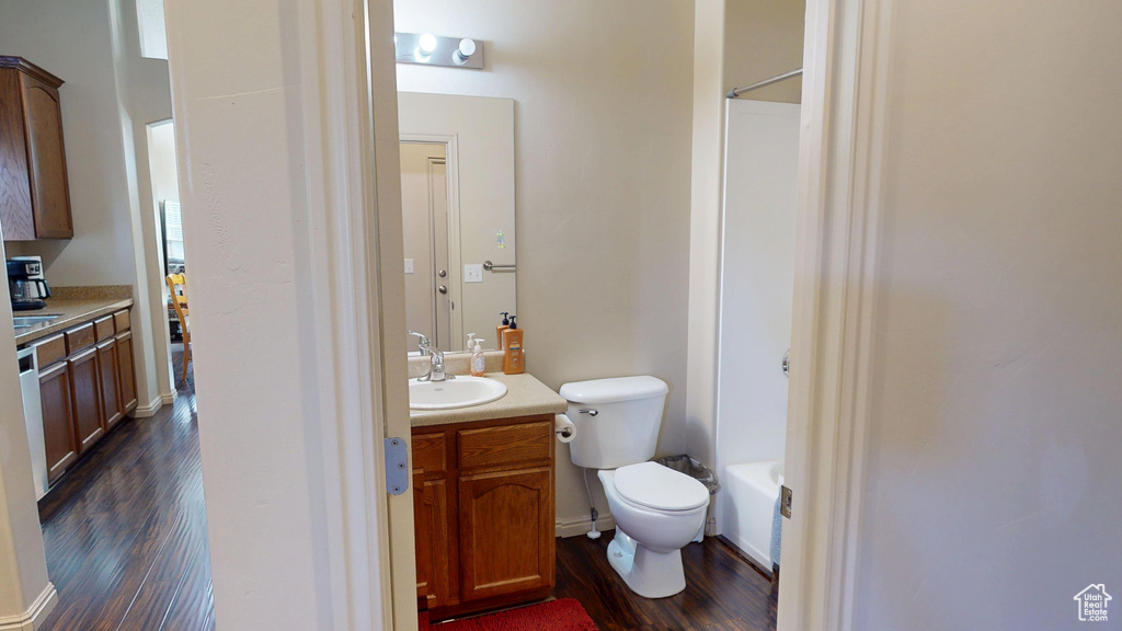 Full bathroom with wood finished floors, vanity, and toilet