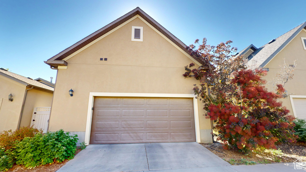 View of front of property with concrete driveway and stucco siding