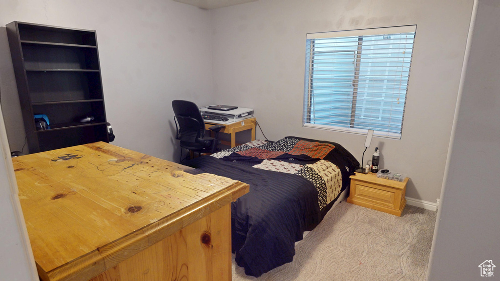 Bedroom featuring light colored carpet and baseboards
