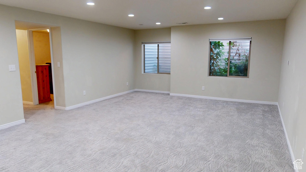 Spare room with recessed lighting, light colored carpet, and plenty of natural light