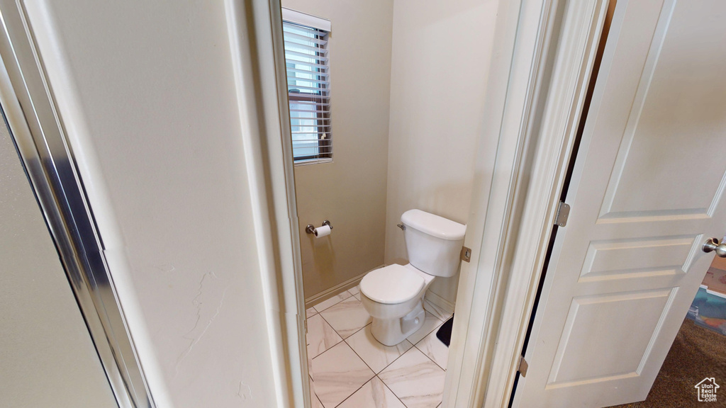 Bathroom featuring toilet and baseboards