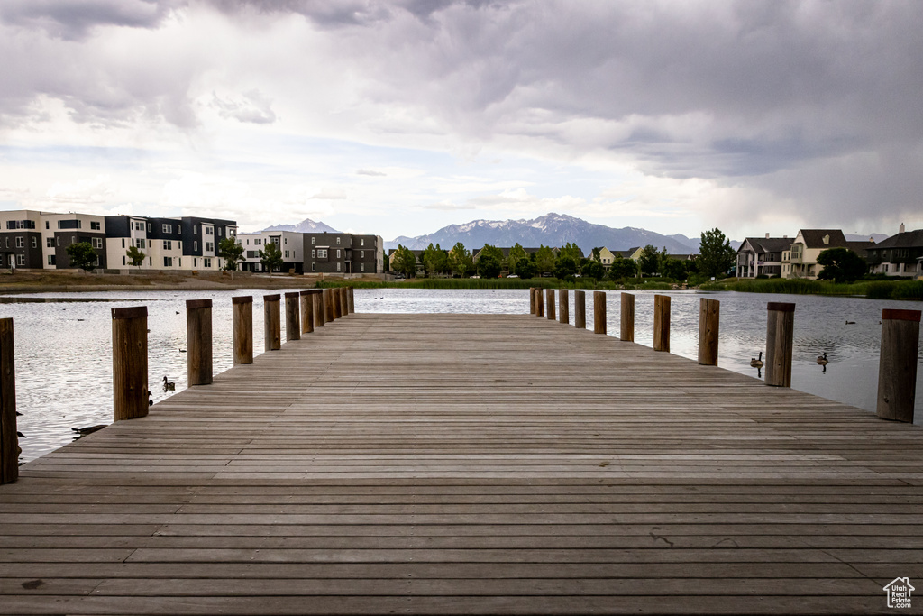 Dock area with a water and mountain view and a residential view