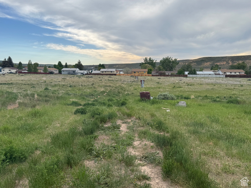 View of yard featuring a view of rural / pastoral area and a mountain view