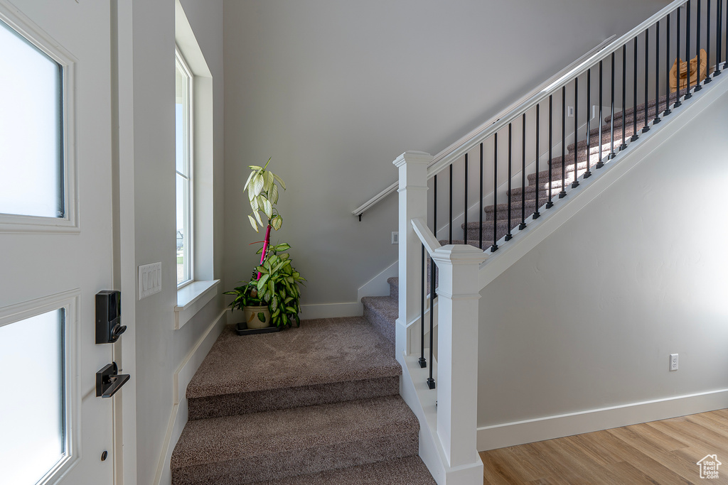 Stairway featuring baseboards and wood finished floors