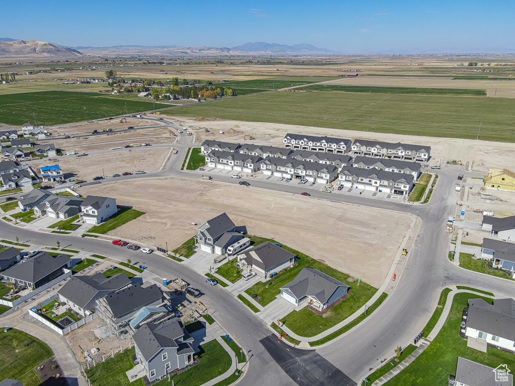 Aerial view of property\'s location with nearby suburban area and a mountainous background