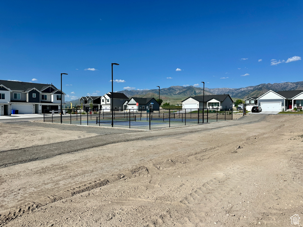 View of property's community with a residential view, a mountain view, and a tennis court