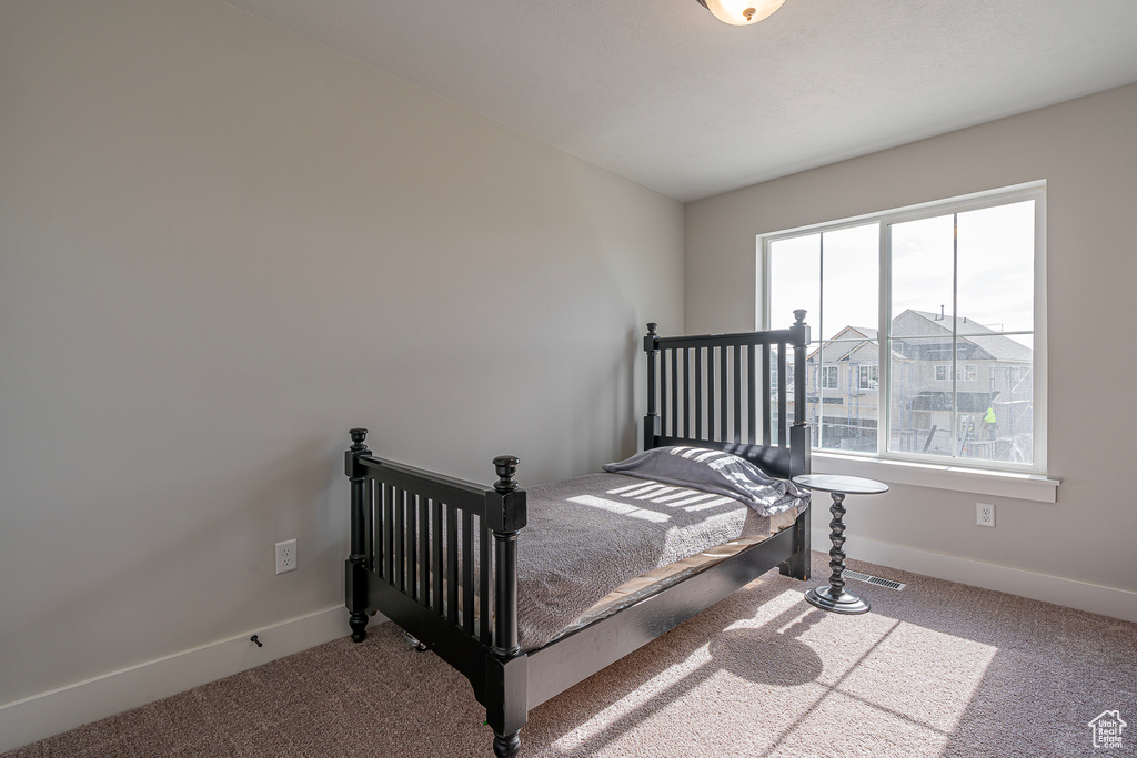 Carpeted bedroom with baseboards