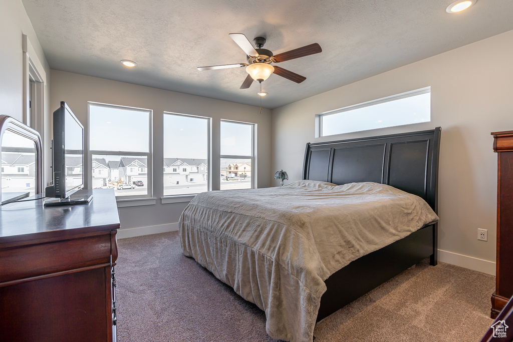 Bedroom featuring carpet flooring, baseboards, ceiling fan, and recessed lighting