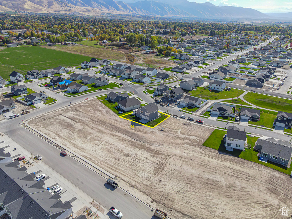 Aerial perspective of suburban area featuring a mountain backdrop and property boundaries highlighted