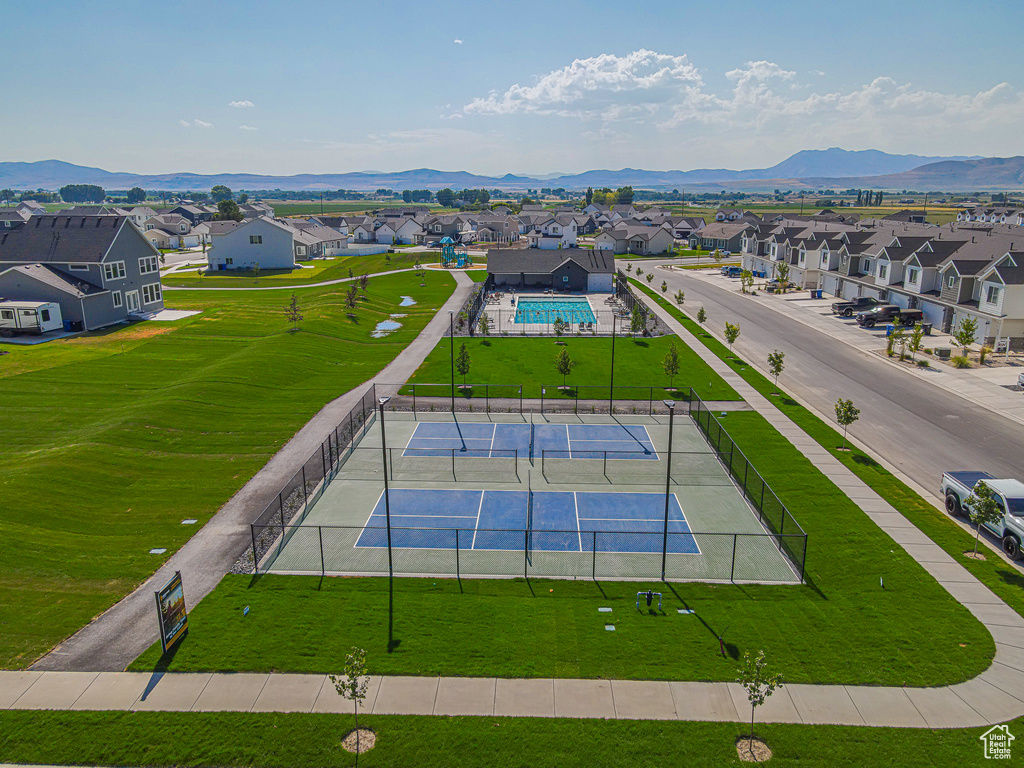 Aerial view of residential area featuring a pool and mountains