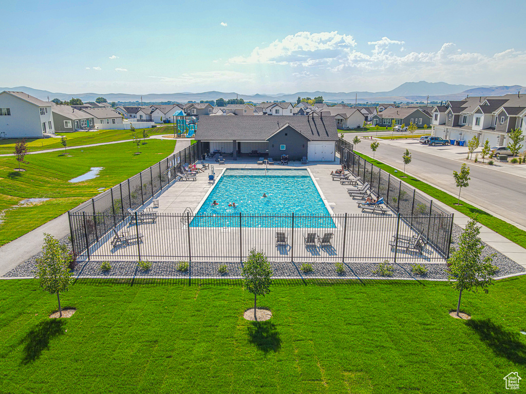 Community pool with a residential view and a mountain view