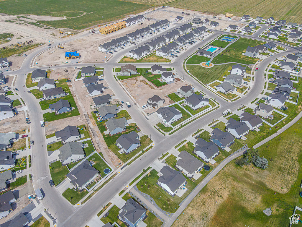 Aerial view of property and surrounding area featuring nearby suburban area