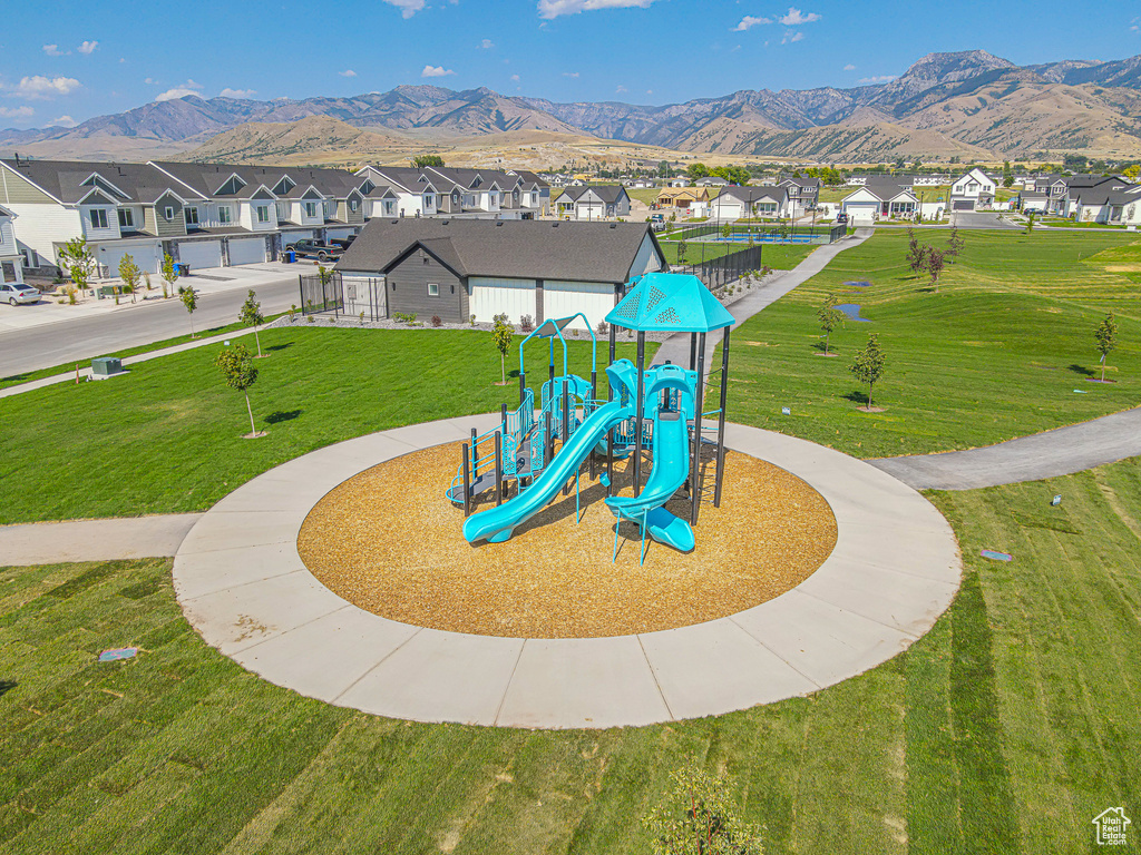 Community jungle gym with a residential view, a mountain view, and a lawn