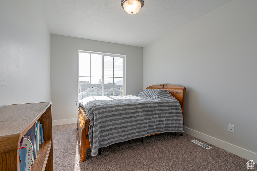 Carpeted bedroom with baseboards