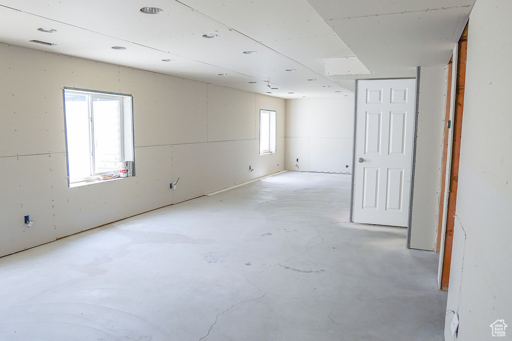 Empty room featuring unfinished concrete floors