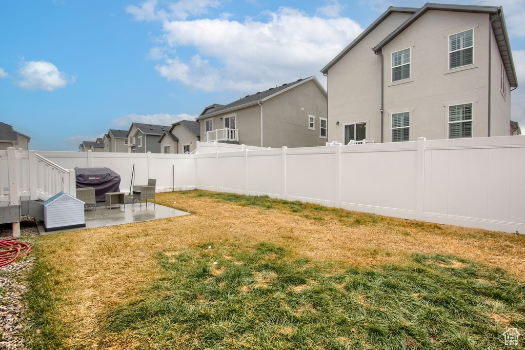 View of yard with a patio area and a residential view