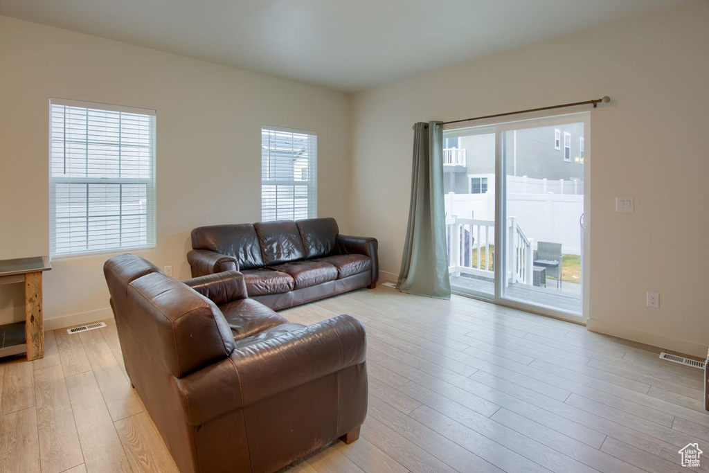 Living room featuring light wood-style flooring and baseboards