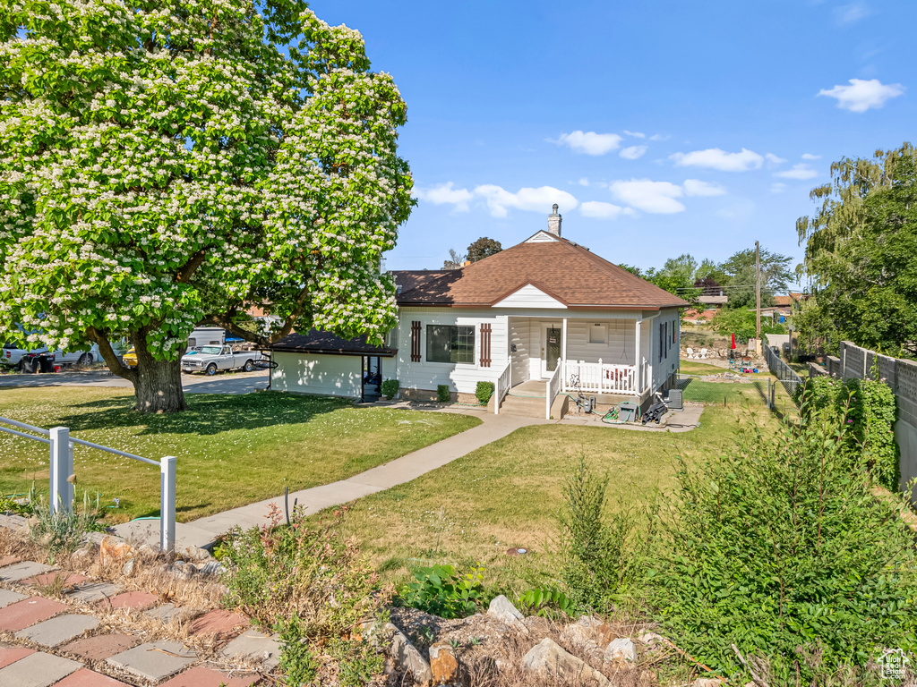 Bungalow-style house featuring covered porch and a shingled roof