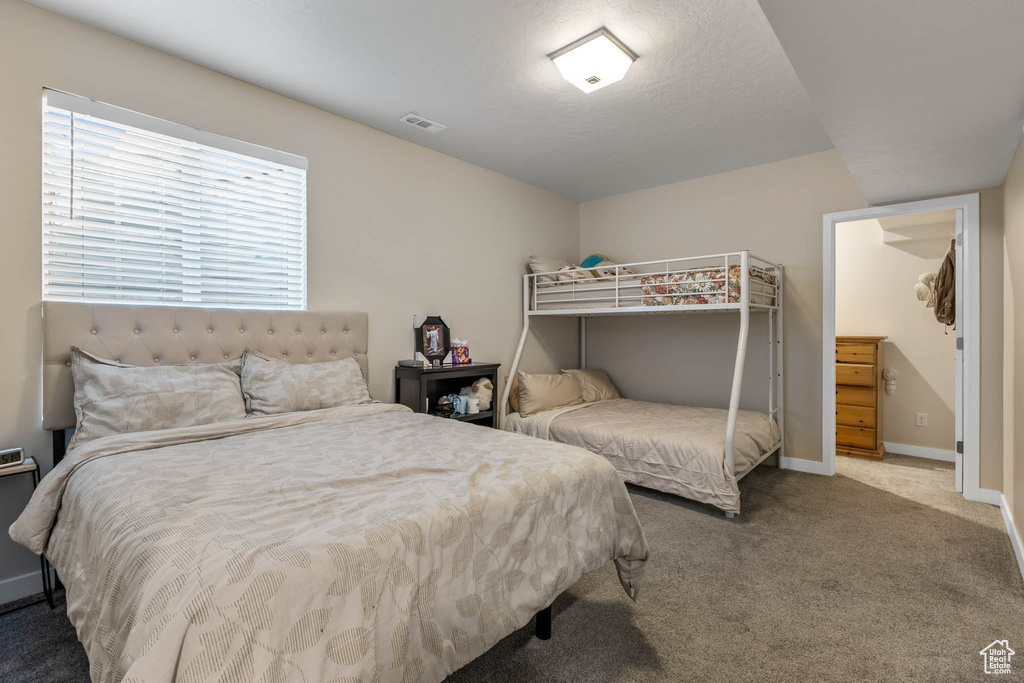 Bedroom featuring carpet floors and baseboards