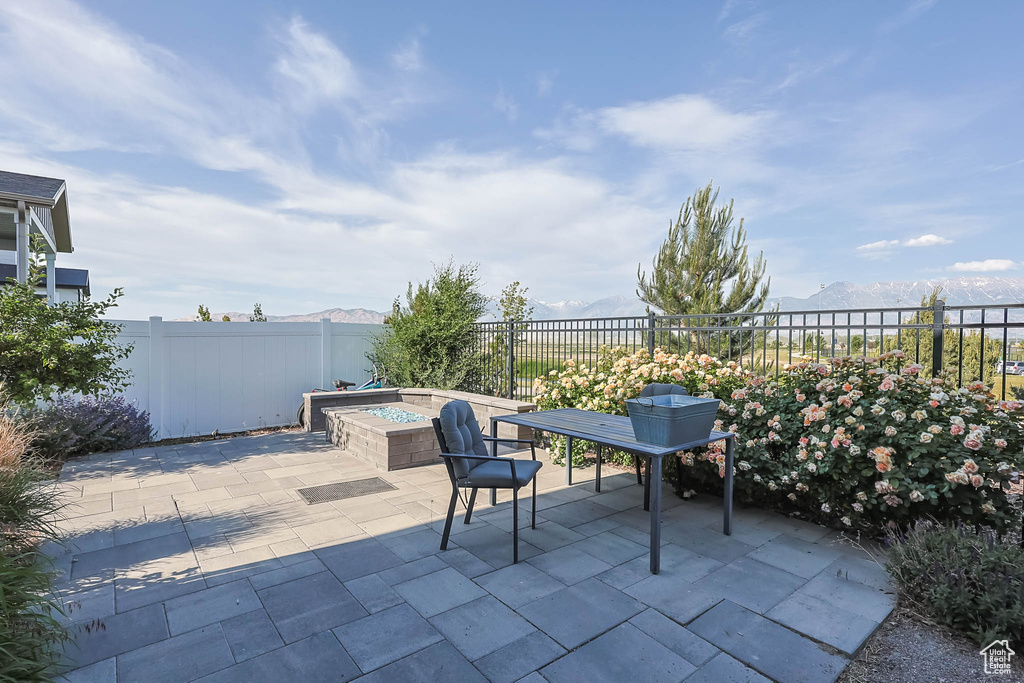 Fenced backyard with a patio area and a mountain view
