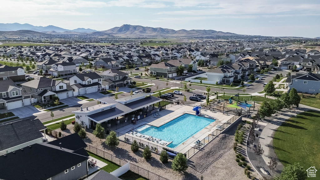 Aerial perspective of suburban area featuring a pool area and mountains