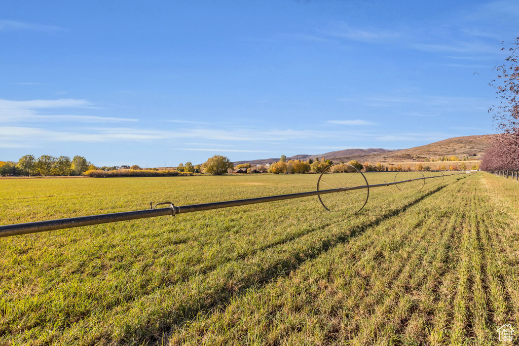 View of green lawn featuring a view of rural / pastoral area and a mountain view