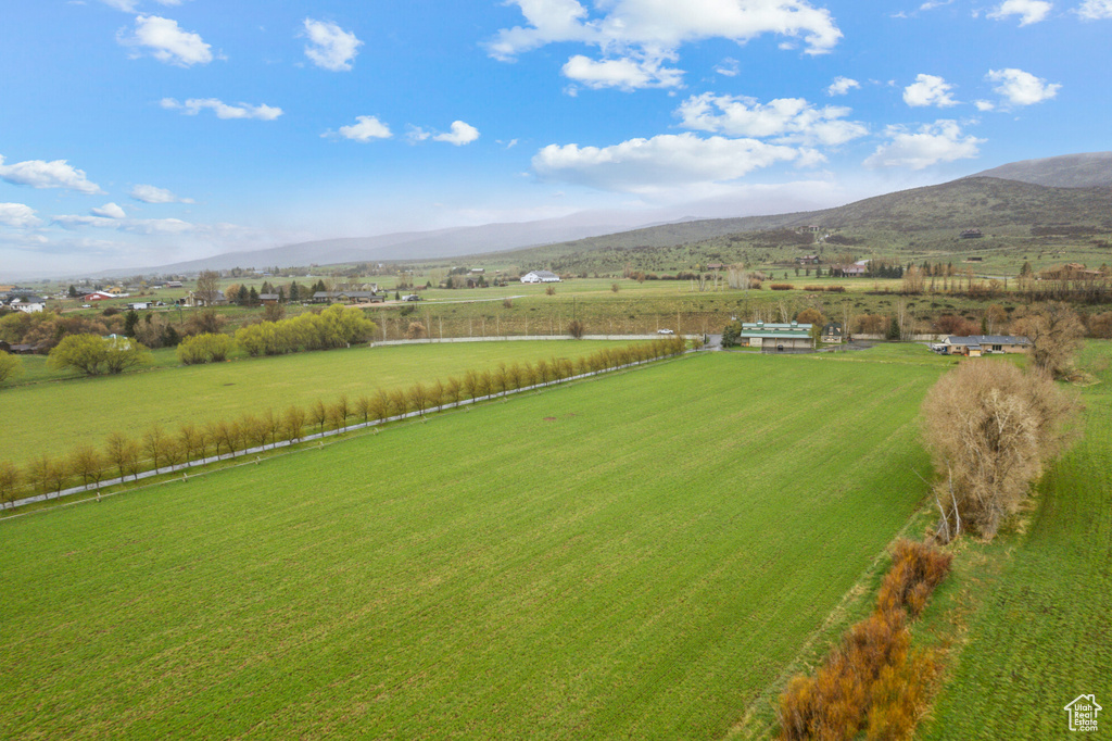 View of rural area featuring mountains and a pastoral area