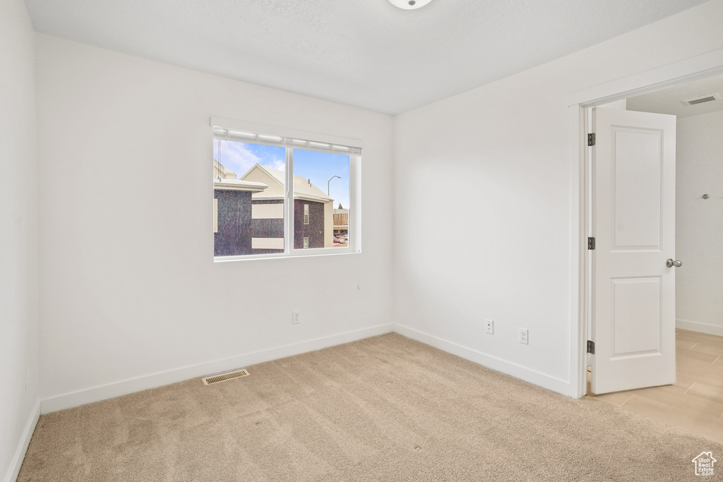 Empty room with carpet flooring and baseboards
